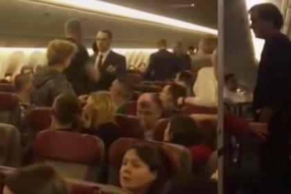 Drunk man tries to open aeroplane door during mid flight Passengers wraps him video